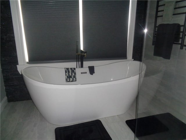 176 Vernon St, Warwick, RI 02889 - bathroom with a towel warming rack, tile patterned flooring, and a freestanding bath