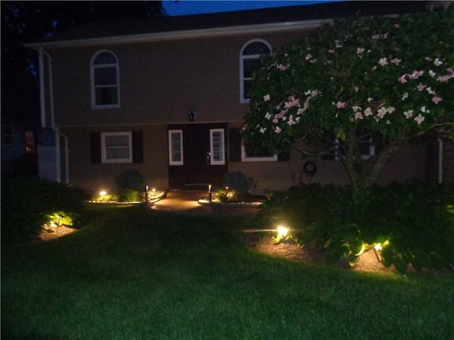 176 Vernon St, Warwick, RI 02889 - back of house at night featuring a yard