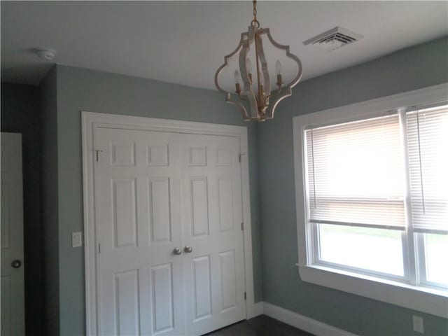 176 Vernon St, Warwick, RI 02889 - unfurnished bedroom featuring a chandelier, a closet, and baseboards