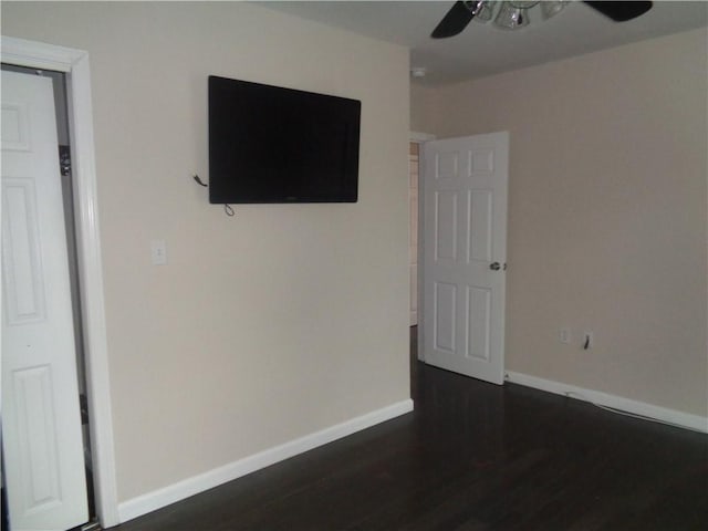 176 Vernon St, Warwick, RI 02889 - unfurnished bedroom featuring dark wood-type flooring, baseboards, and a ceiling fan