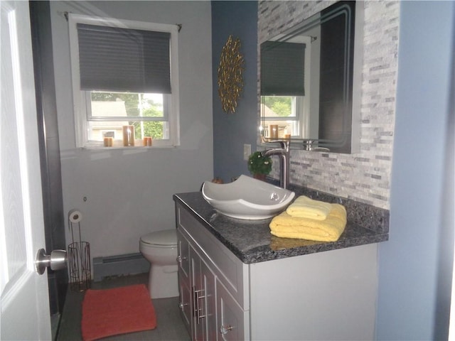 176 Vernon St, Warwick, RI 02889 - bathroom with baseboard heating, vanity, healthy amount of natural light, and tasteful backsplash