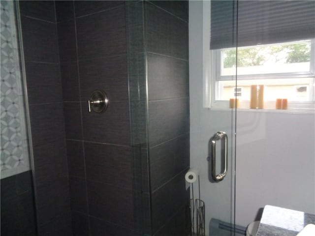 176 Vernon St, Warwick, RI 02889 - bathroom featuring a stall shower, plenty of natural light, toilet, and a baseboard heating unit