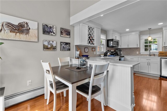 37 Brownell St, Warren, RI 02885 - dining area featuring a baseboard radiator, recessed lighting, and light wood finished floors