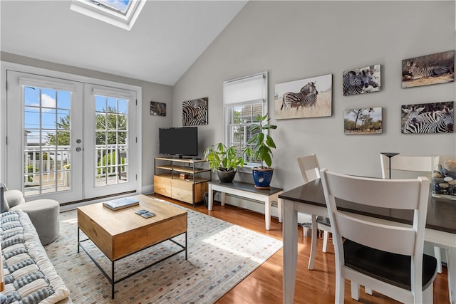 37 Brownell St, Warren, RI 02885 - living room with french doors, plenty of natural light, wood finished floors, and high vaulted ceiling