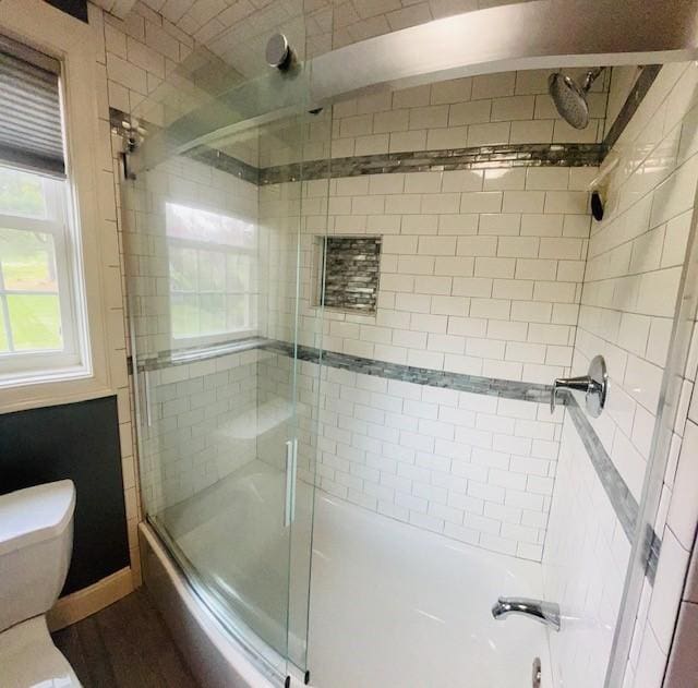 1221 Phenix Ave, Cranston, RI 02921 - bathroom with combined bath / shower with glass door and toilet