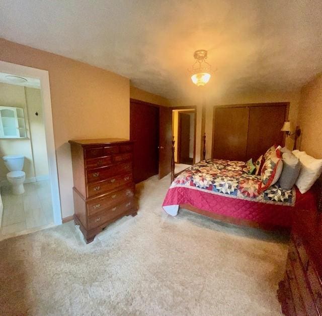 1221 Phenix Ave, Cranston, RI 02921 - bedroom with light carpet, ensuite bathroom, and multiple closets