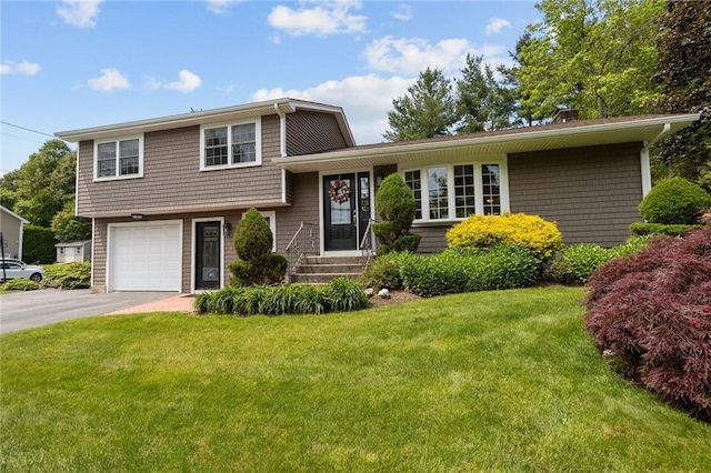 1221 Phenix Ave, Cranston, RI 02921 - split level home with driveway, a front yard, a chimney, and an attached garage