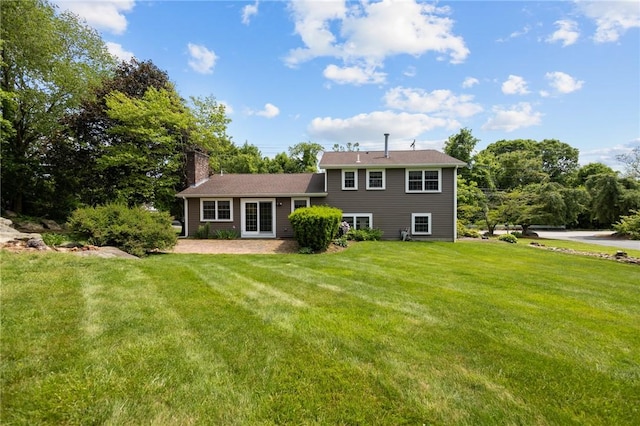 1221 Phenix Ave, Cranston, RI 02921 - back of house with a lawn and a chimney