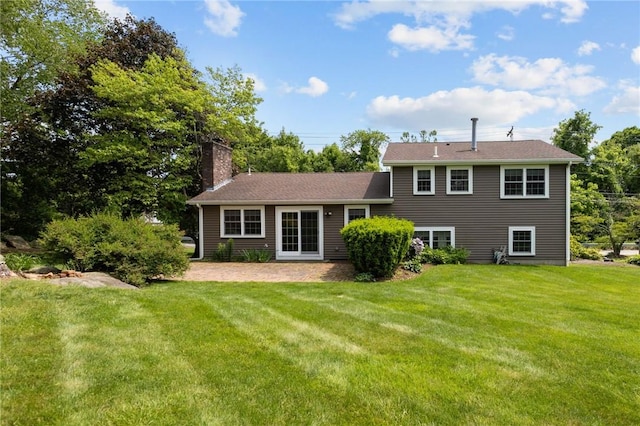 1221 Phenix Ave, Cranston, RI 02921 - rear view of property featuring a chimney, a yard, and a patio area