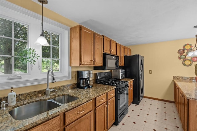1221 Phenix Ave, Cranston, RI 02921 - kitchen with black appliances, a sink, brown cabinetry, and baseboards