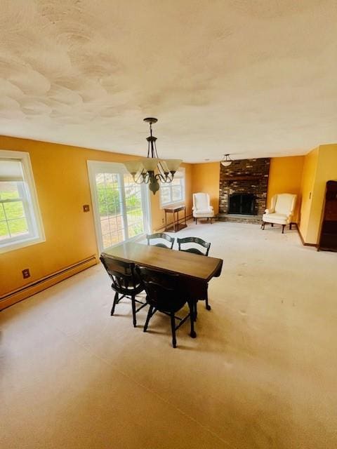 1221 Phenix Ave, Cranston, RI 02921 - dining area with a brick fireplace, a chandelier, baseboards, light colored carpet, and a baseboard heating unit