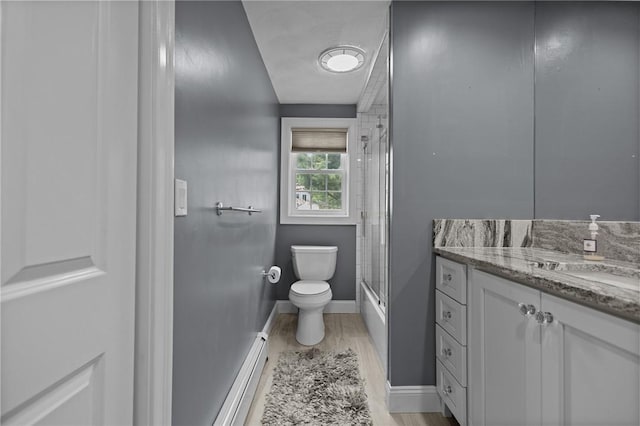 1221 Phenix Ave, Cranston, RI 02921 - bathroom featuring vanity, toilet, bath / shower combo with glass door, baseboards, and wood finished floors