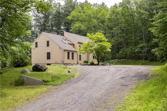 71 Phillips Ln, Glocester, RI 02814 - view of front of property featuring driveway, a chimney, a front lawn, a shingled roof, and a wooded view