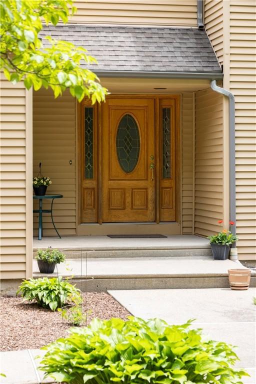 71 Phillips Ln, Glocester, RI 02814 - entrance to property with a shingled roof and a porch