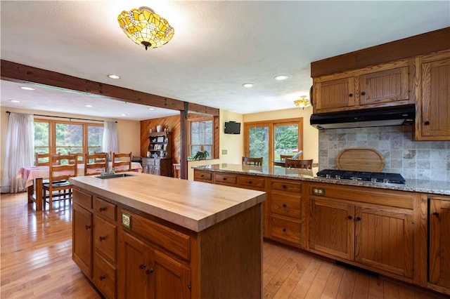 71 Phillips Ln, Glocester, RI 02814 - kitchen featuring under cabinet range hood, stainless steel gas cooktop, wooden counters, a sink, and light wood-type flooring