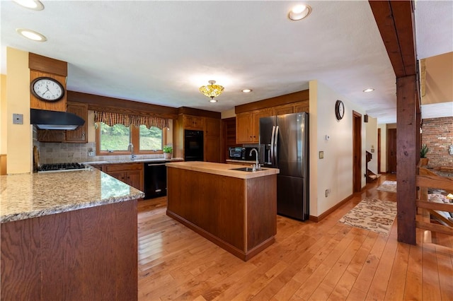 71 Phillips Ln, Glocester, RI 02814 - kitchen featuring black appliances, extractor fan, a center island with sink, light wood-type flooring, and recessed lighting