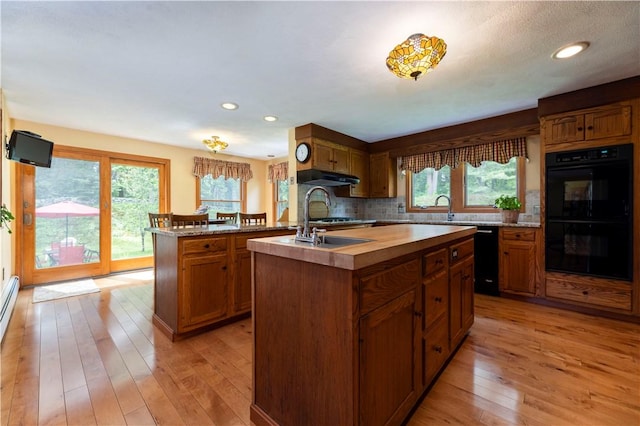 71 Phillips Ln, Glocester, RI 02814 - kitchen with black appliances, under cabinet range hood, a kitchen island with sink, healthy amount of natural light, and recessed lighting
