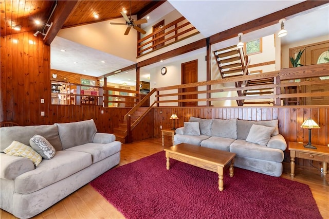 71 Phillips Ln, Glocester, RI 02814 - living area with wooden walls, wood finished floors, stairs, high vaulted ceiling, and ceiling fan