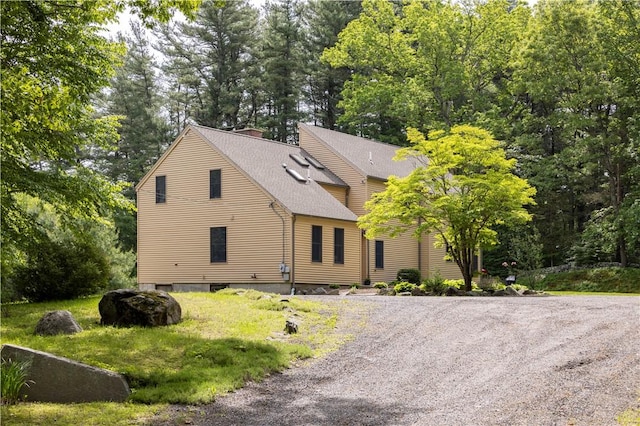71 Phillips Ln, Glocester, RI 02814 - view of front of home with roof with shingles, a chimney, and view of wooded area
