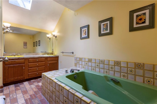 71 Phillips Ln, Glocester, RI 02814 - full bathroom with double vanity, a garden tub, lofted ceiling, and a skylight