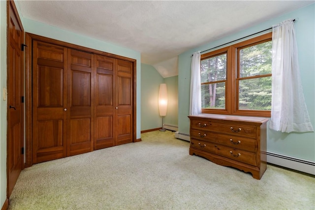 71 Phillips Ln, Glocester, RI 02814 - bedroom featuring light carpet, baseboards, lofted ceiling, a baseboard radiator, and a closet