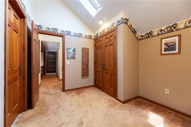 71 Phillips Ln, Glocester, RI 02814 - corridor with light colored carpet, a skylight, baseboards, and high vaulted ceiling