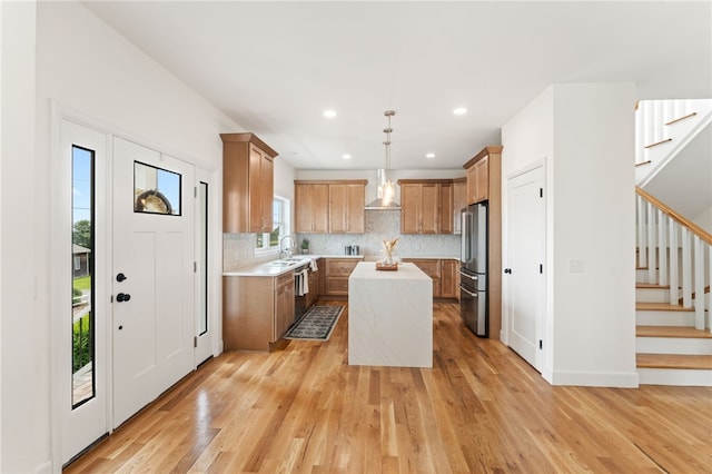 51 Burnett Rd, Warwick, RI 02889 - kitchen with freestanding refrigerator, light countertops, wall chimney exhaust hood, light wood-style flooring, and recessed lighting