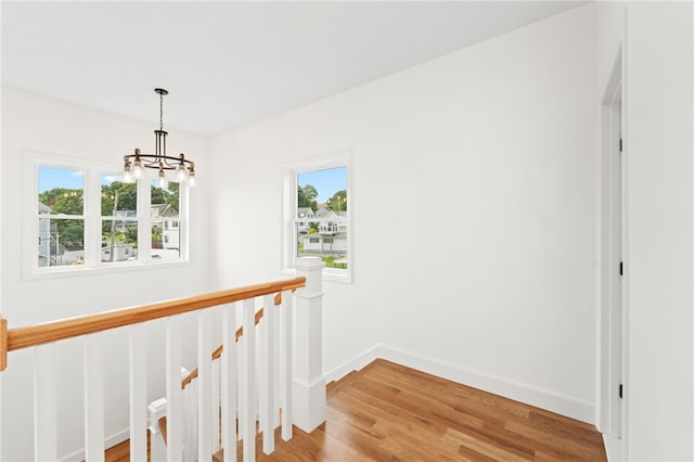 51 Burnett Rd, Warwick, RI 02889 - hallway featuring a chandelier, an upstairs landing, light wood-type flooring, and baseboards