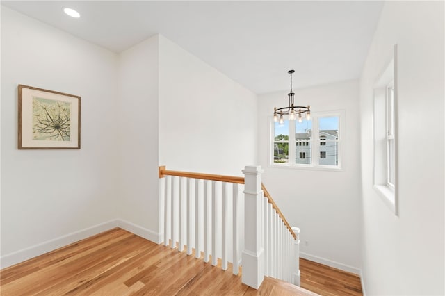51 Burnett Rd, Warwick, RI 02889 - staircase featuring a chandelier, wood finished floors, and baseboards
