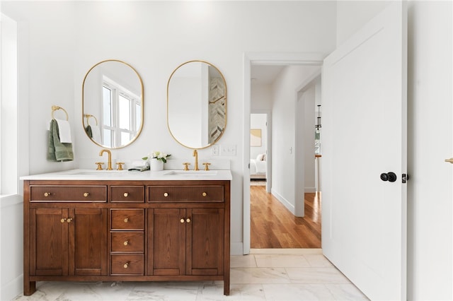 51 Burnett Rd, Warwick, RI 02889 - full bathroom featuring marble finish flooring, double vanity, and baseboards