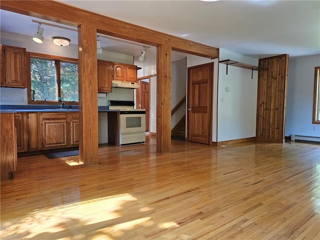 66 Shadbush Rd, South Kingstown, RI 02879 - kitchen featuring range with electric stovetop, under cabinet range hood, brown cabinets, and light wood-style floors