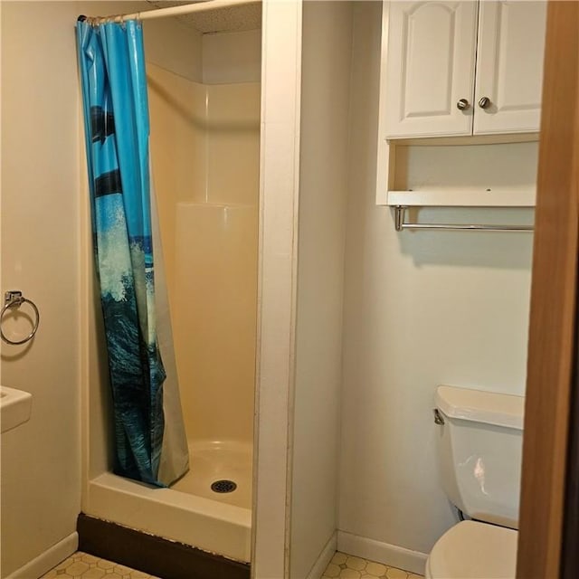 66 Shadbush Rd, South Kingstown, RI 02879 - full bathroom featuring a shower stall, toilet, baseboards, and tile patterned flooring