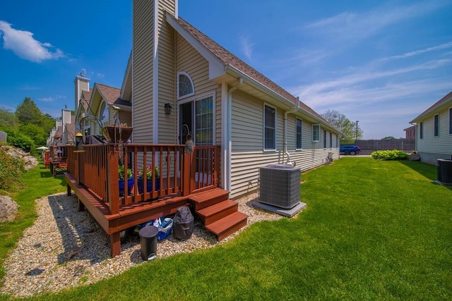 1421 Douglas Ave Unit E, North Providence, RI 02904 - rear view of house with cooling unit, a chimney, a wooden deck, and a lawn