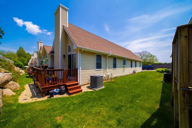 1421 Douglas Ave Unit E, North Providence, RI 02904 - back of house with a wooden deck, a chimney, roof with shingles, and a lawn