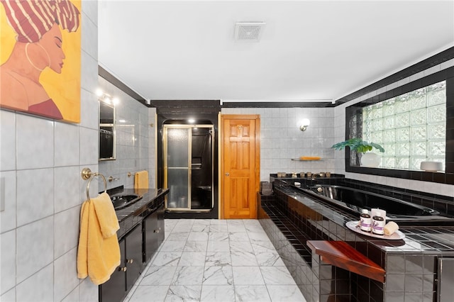 336 Switch Rd, Richmond, RI 02832 - bathroom with marble look tiles, tile walls, a bath, vanity, and crown molding