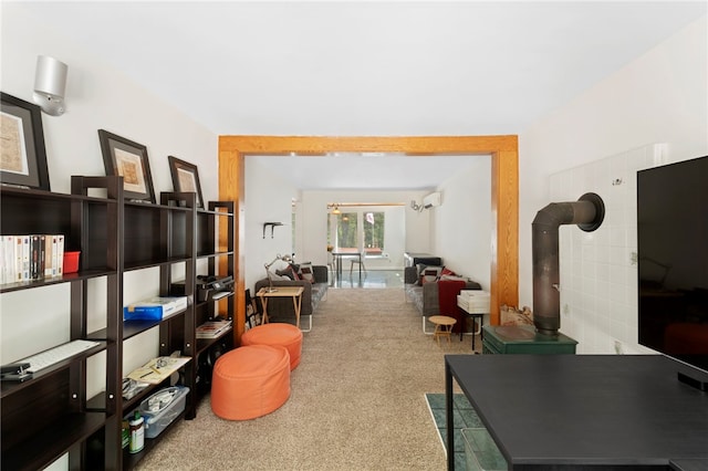 336 Switch Rd, Richmond, RI 02832 - living area featuring carpet, a wall mounted AC, and a wood stove