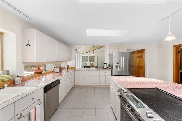 336 Switch Rd, Richmond, RI 02832 - kitchen featuring stainless steel appliances, a skylight, light tile patterned flooring, white cabinetry, and light countertops