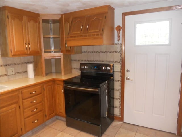 20 Anchorage Rd, Narragansett, RI 02882 - kitchen featuring black / electric stove, backsplash, light countertops, light tile patterned flooring, and brown cabinetry