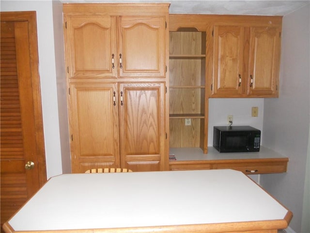 20 Anchorage Rd, Narragansett, RI 02882 - kitchen with black microwave, light countertops, open shelves, and a center island