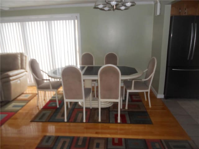 20 Anchorage Rd, Narragansett, RI 02882 - dining area featuring a chandelier, ornamental molding, wood finished floors, and baseboards