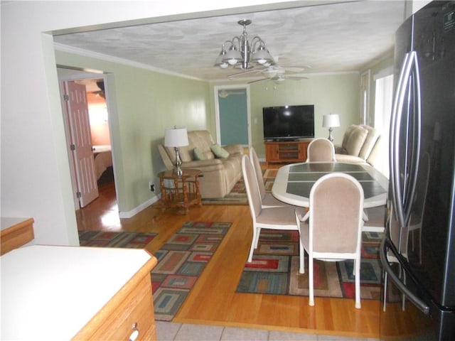 20 Anchorage Rd, Narragansett, RI 02882 - dining area with ornamental molding, ceiling fan, a chandelier, wood finished floors, and baseboards