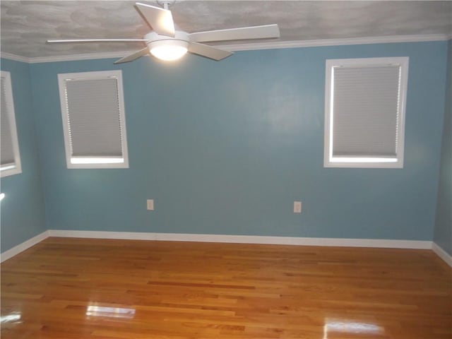20 Anchorage Rd, Narragansett, RI 02882 - spare room with wood finished floors, baseboards, ceiling fan, and ornamental molding