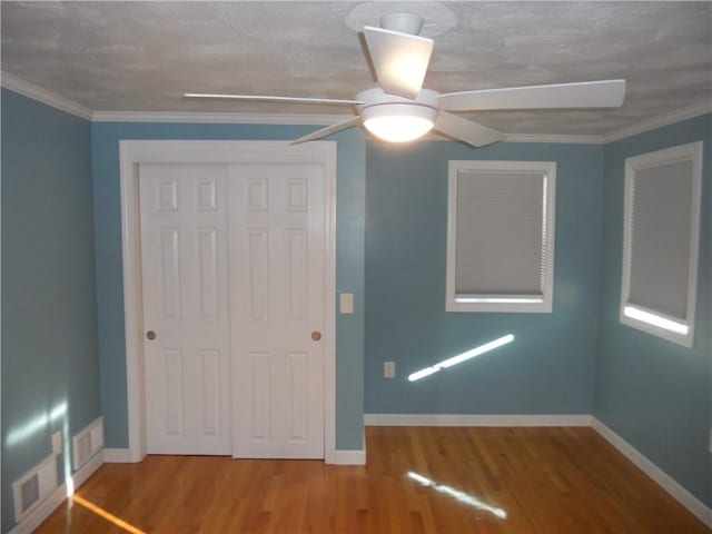 20 Anchorage Rd, Narragansett, RI 02882 - unfurnished bedroom featuring wood finished floors, a closet, baseboards, and ornamental molding