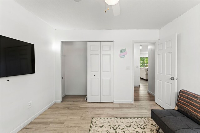 694 Orleans Ct, Warwick, RI 02886 - living room with light wood-type flooring, a ceiling fan, and baseboards