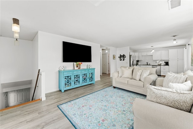 694 Orleans Ct, Warwick, RI 02886 - living room featuring light wood-type flooring and baseboards