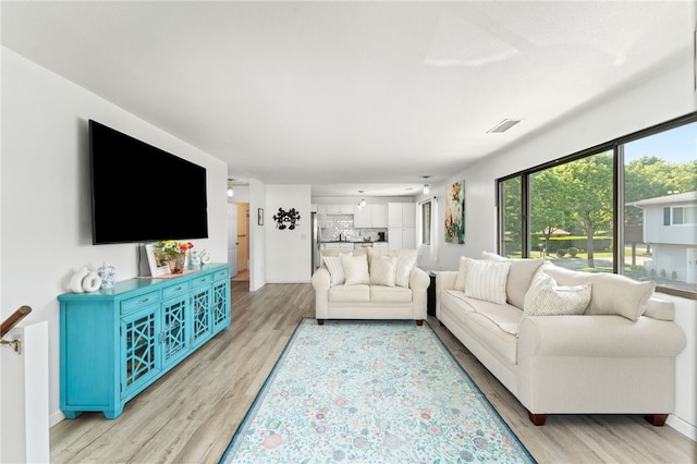 694 Orleans Ct, Warwick, RI 02886 - living room with light wood-type flooring and baseboards