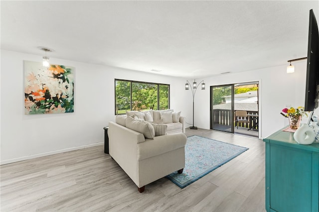 694 Orleans Ct, Warwick, RI 02886 - living room with light wood-type flooring and baseboards