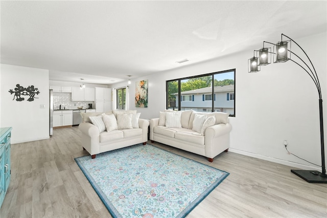 694 Orleans Ct, Warwick, RI 02886 - living room with light wood finished floors and baseboards