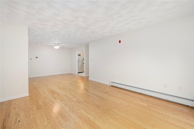 752 Quaker Ln Unit C311, Warwick, RI 02818 - empty room with baseboard heating, light wood-type flooring, and ceiling fan