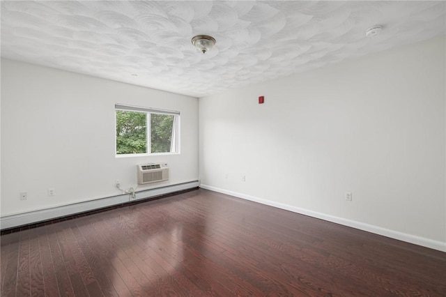 752 Quaker Ln Unit C311, Warwick, RI 02818 - empty room featuring a baseboard radiator, dark wood-style flooring, a textured ceiling, and a wall mounted air conditioner